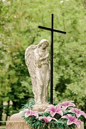 Graveyard monument: crying angel and crossの写真素材