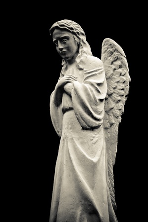 Statue of a crying angel, isolated on black background. Black and whiteの写真素材