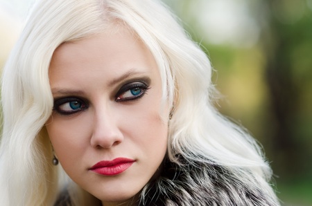 Closeup portrait of a beautiful young woman in fur jacketの写真素材