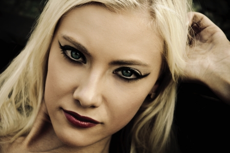 Closeup portrait of beautiful young woman in noir styleの写真素材