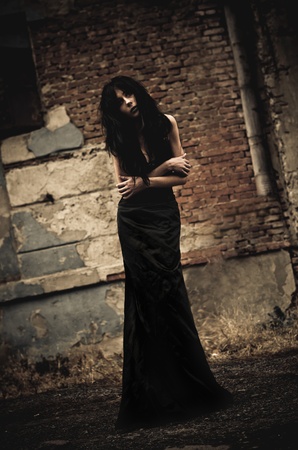 Gloomy portrait of a sick goth girl among the ruins  Low keyの写真素材