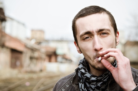Closeup portrait of handsome smoking young manの写真素材