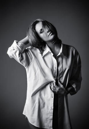 Studio portrait of seductive young girl wearing white shirt  Black and whiteの写真素材