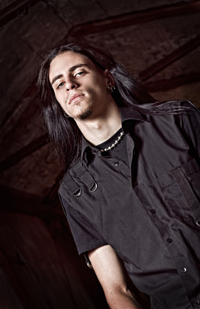 Portrait of a handsome young man with long hair  Low keyの写真素材