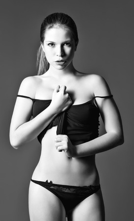 Studio fashion shot of pretty young woman in shirt and panties  Black and whiteの写真素材