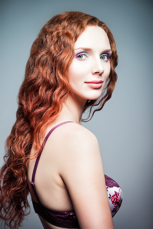 Closeup studio portrait of a pretty redhead woman  Half-turned   の写真素材