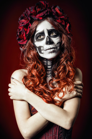 The sad young woman with muertos makeup (sugar skull)の写真素材