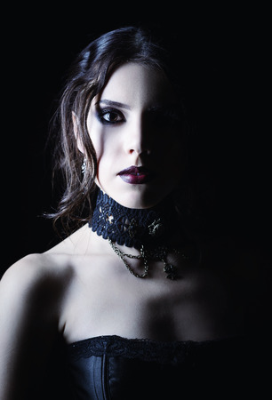 Closeup portrait of a beautiful young goth girl in cold tonesの写真素材