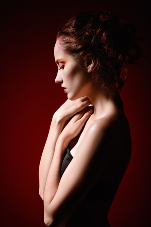 Portrait of a beautiful sad redhead girl. Profile viewの写真素材