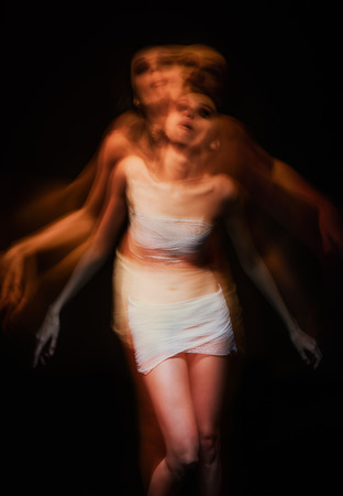 Shivering blurry portrait of a sick mad womanの写真素材