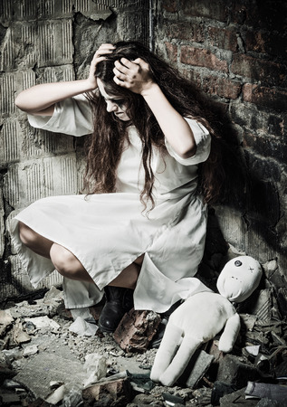 Horror style shot: the strange crazy girl and her moppet dollの写真素材