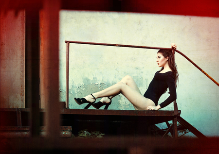 Outdoor fashion shot: a beautiful young girl in black body. Grunge and glitch effects の写真素材