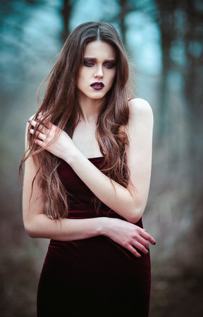 Outdoor portrait of a lovely sad young womanの写真素材