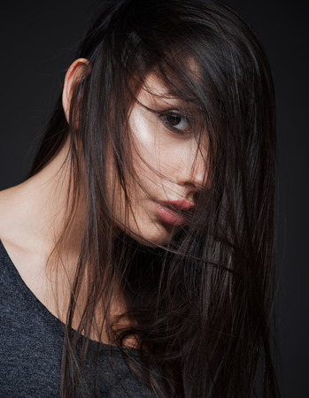 Studio closeup portrait of a beautiful young girlの写真素材