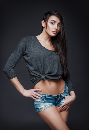 Studio fashion shot: portrait of pretty young girl in denim shorts and jersey. Model test
の写真素材
