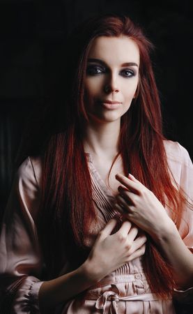 Portrait of pretty young girl in pink a dressの写真素材
