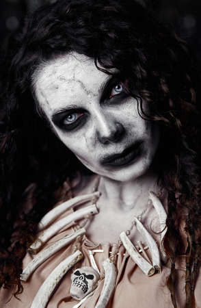 Halloween theme: creepy ugly voodoo witch. Close-up portrait of the evil sorceress. Zombie woman (undead)の写真素材