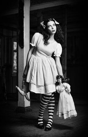 The strange girl with dolls in hands. Black and whiteの写真素材