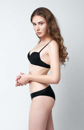 Studio fashion shot: a beautiful young girl wearing black lingerie. Model testの写真素材