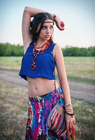 Outdoor portrait of the attractive young boho (hippie) girl in the fieldの写真素材