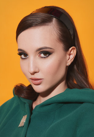 Attractive girl in sixties style. Retro (vintage) close-up portrait of beautiful young woman. 60's look dressed ladyの写真素材
