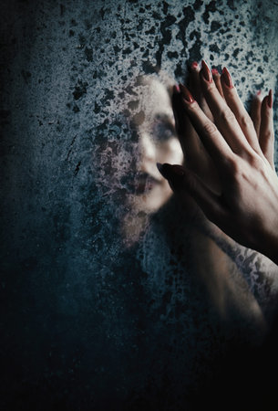 Horror scene: blurry reflection of the ghost girl in old dirty mirror