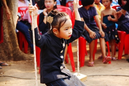Girl dressed in Native swings ride のeditorial素材