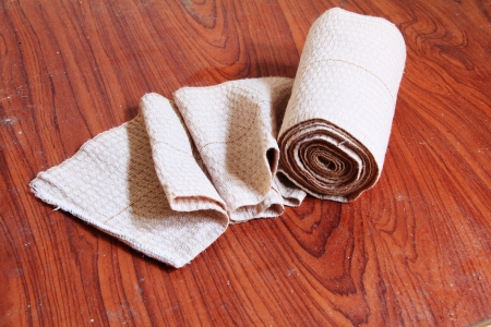 medical gauze bandage on wood floors の写真素材