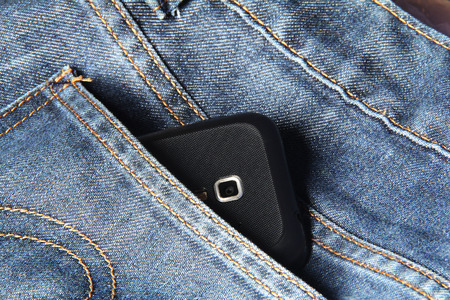 Mobile phone in blue jeans pocket.の写真素材