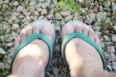 feet of a man wearing Sandals