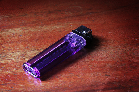 violet lighter on the wooden floorの写真素材