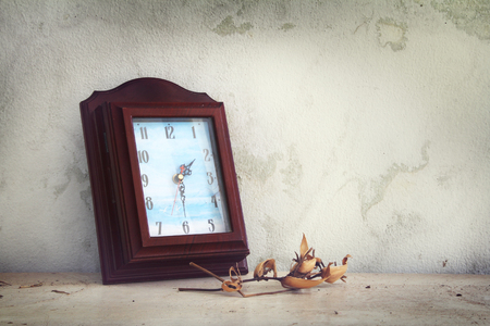 clock and dried flowers on the old woodenの写真素材