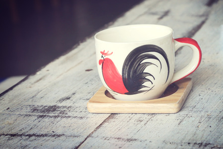 Cup on a wooden table. Vintage styleの写真素材