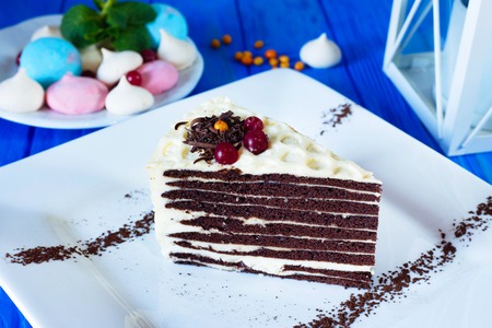 Piece of chocolate layered cake with butter creamの写真素材