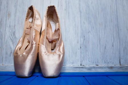 Ballet pointe shoes on bright color  wooden background, free  spの写真素材