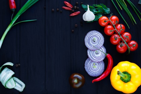 Top view on table with various tomatoes, onion slices, chili pepの写真素材