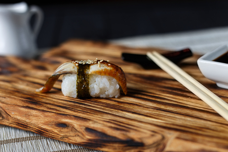 Delicious fresh nigiri with smoked eel served on wooden rustic tの写真素材