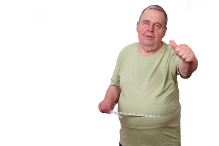 Portrait of old overweight man with measuring tape around waist.の写真素材