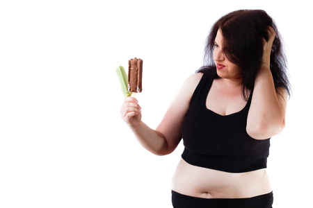 Overweight woman resists to eat ice-cream. Healthy food concept.の写真素材