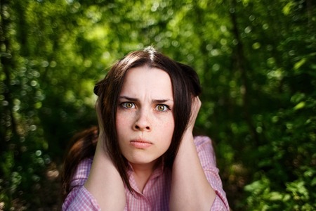 Young woman closing ears.の写真素材