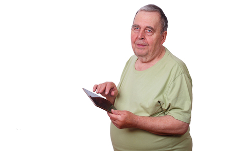 Portrait of senior man pensioner using tablet, typing message, iの写真素材