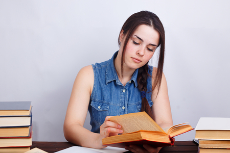 Portrait of young student girl reading a bookの写真素材