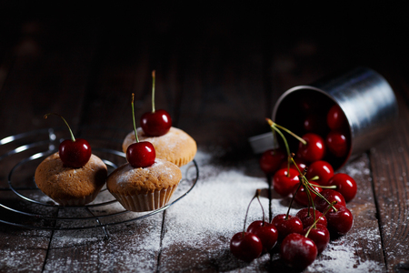 Delicious cakes and sprinkled cherries on rustic wooden table. Kの写真素材