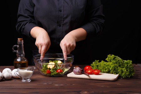 Chef cooking salad. Food preparation processの写真素材