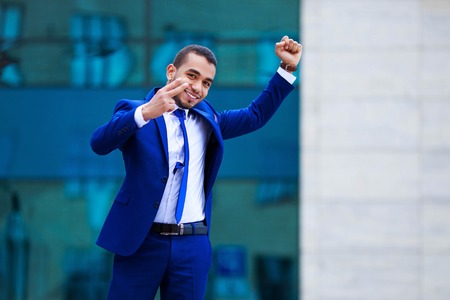 Young attractive business man in suit celebrating success, demonの写真素材