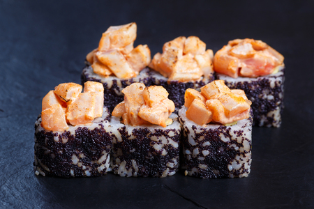 Sushi rolls topped with torched salmon and black caviar  servedの写真素材