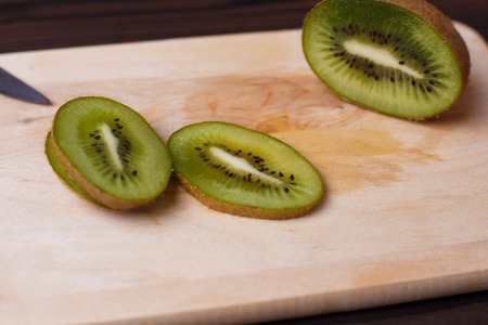 Kiwi slices on chopping board. Tasty natural fruit dessertの写真素材