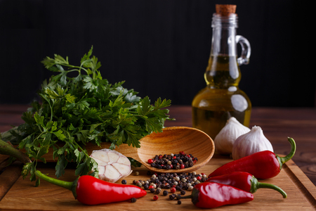 Olive oil, garlic, herbs and spices on wooden table. Kitchen bacの写真素材