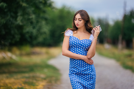 Portrait of woman with smart phone. Cropped image of young prettの写真素材