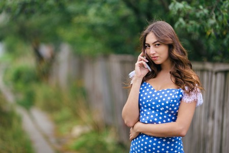 Portrait of woman talking on smart phone.Cropped image of youngの写真素材